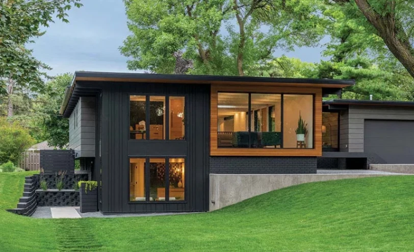 Mid-century modern house exterior featuring low-pitch rooflines, clerestory windows, and natural stone accents