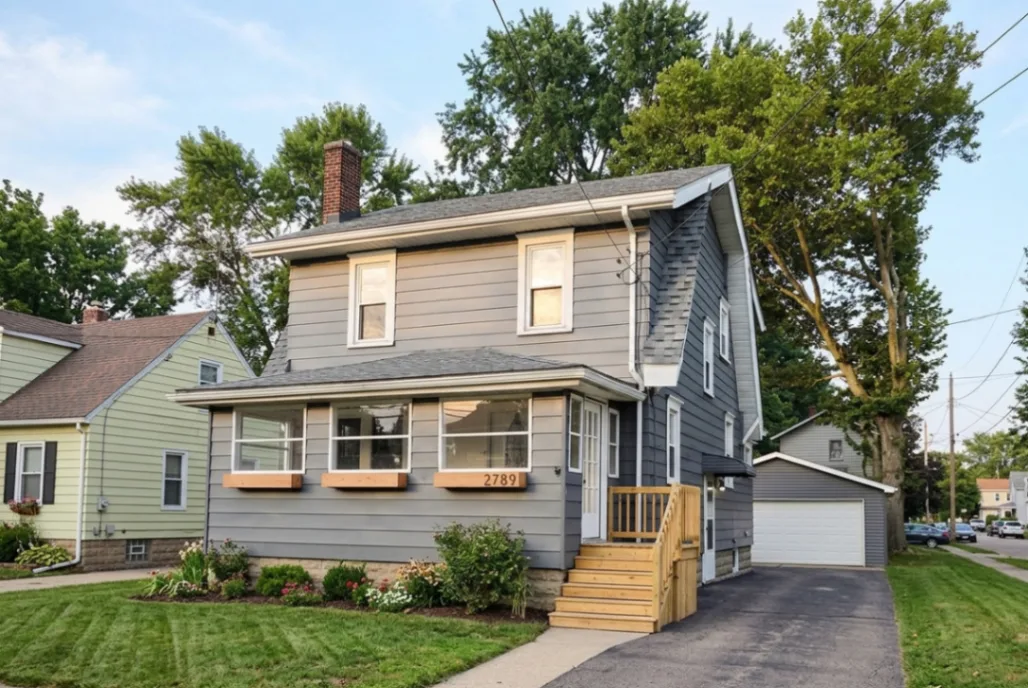 Suburban home exterior visualizer previewing Sherwin-Williams Web Gray SW 7075 paint with black trim